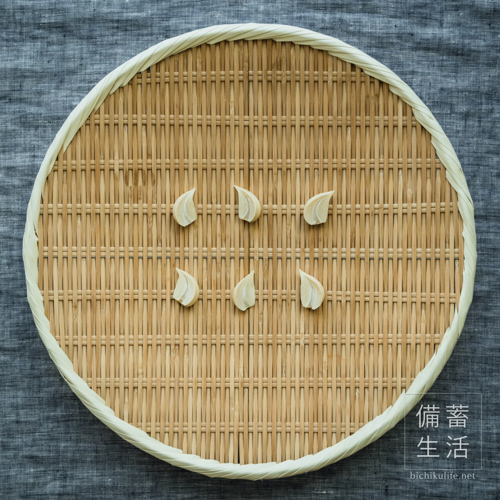 Garlic cloves halved lengthwise, dried on a bamboo basket