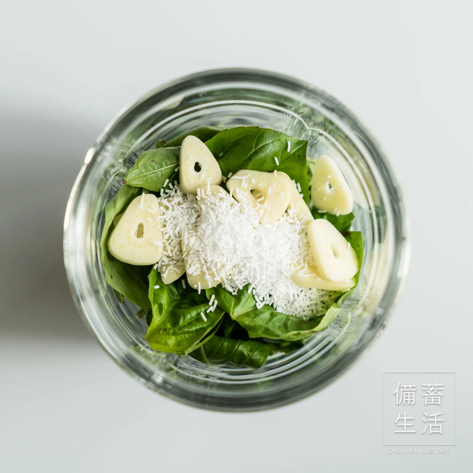 Blending basil with garlic and olive oil
