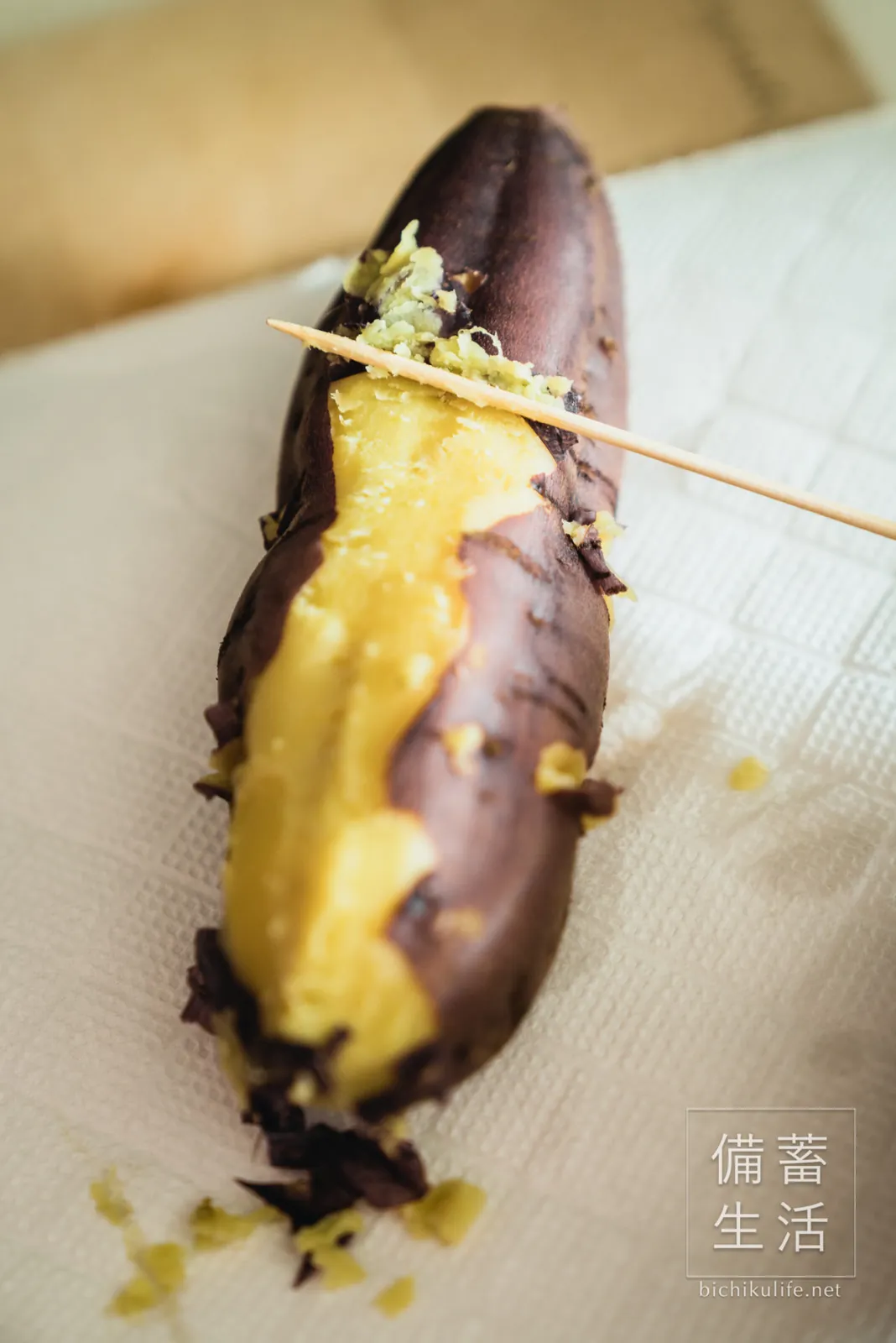 Peeling a hot steamed sweet potato with a bamboo skewer