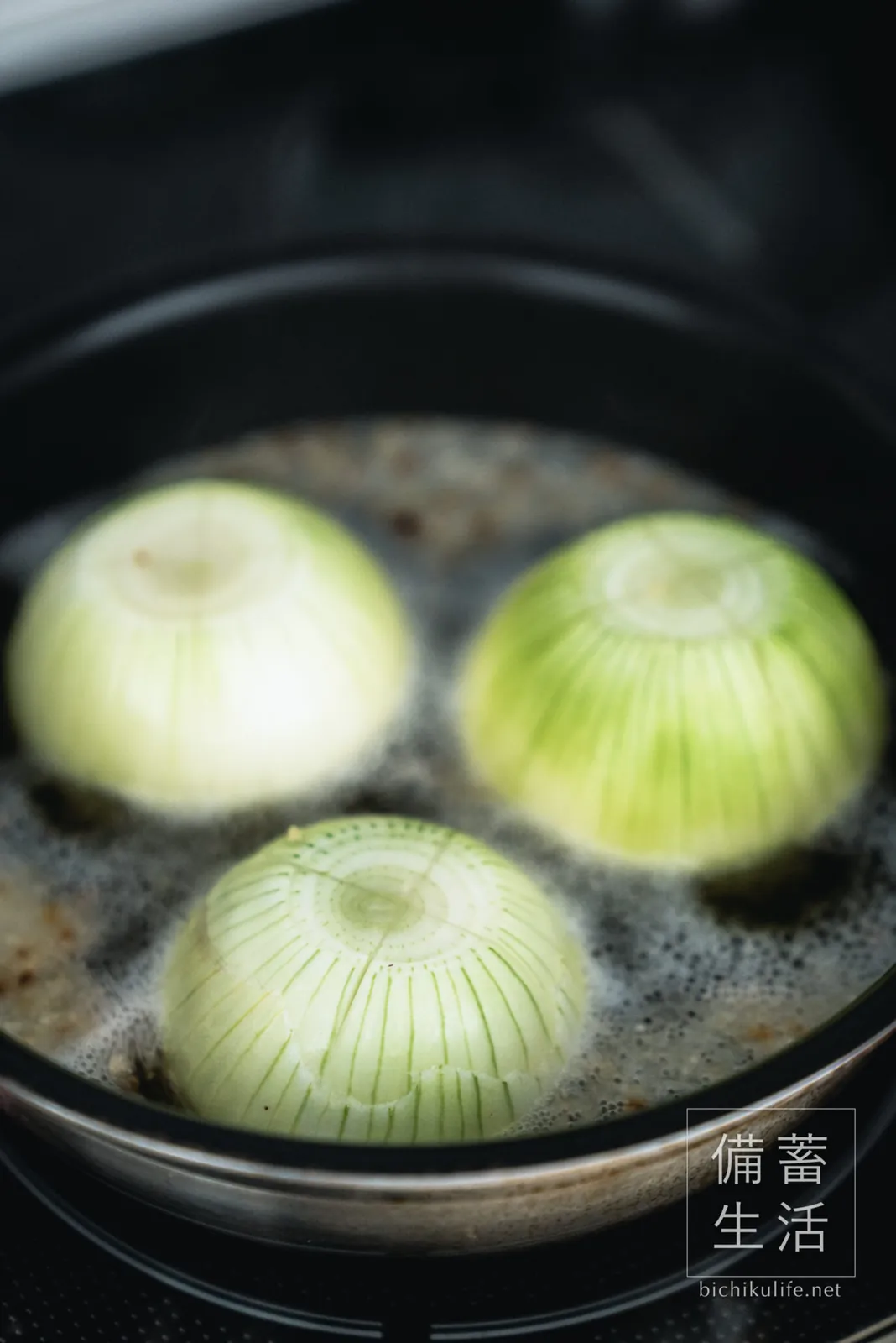 Onions simmering under a parchment drop lid